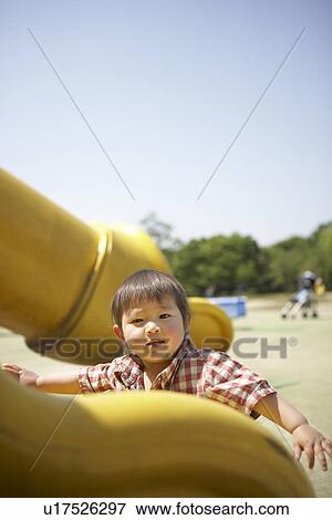 Stock Photo - Baby Boy on Slide. Fotosearch