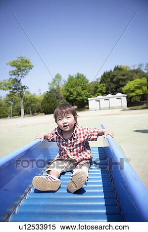 Stock Photography - Baby Boy on Slide. Fotosearch