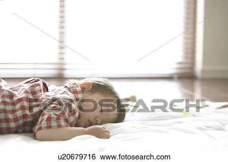 Stock Photograph - Baby Boy Sleeping on Floor. Fotosearch