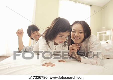 Baby Girl and Parents in Bed View Large Photo Image Stock Image - Baby Girl and Parents in Bed. Fotosearch
