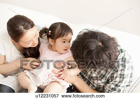 Baby Girl and Parents View Large Photo Image Stock Photo - Baby Girl and Parents. Fotosearch