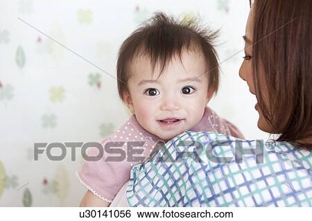 Baby Girl in Mothers Arms View Large Photo Image Stock Photograph - Baby Girl in Mothers Arms. Fotosearch