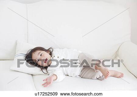Baby Girl Lying on Sofa View Large Photo Image Stock Photo - Baby Girl Lying on Sofa. Fotosearch