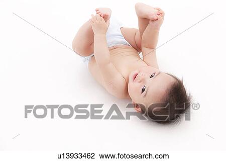 Stock Image - Baby Holding Toes. Fotosearch