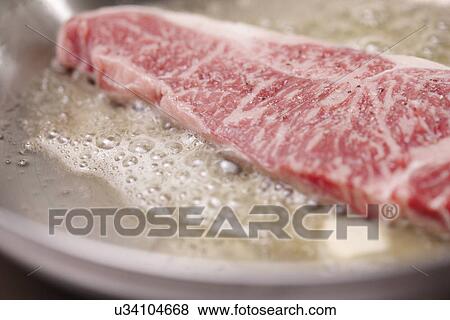 Stock Photo - Beef Being Fried. Fotosearch