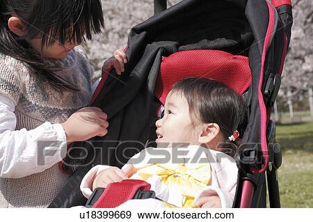 Big Sister Talking to Little Sister in Buggy View Large Photo Image Stock Photo - Big Sister Talking to Little Sister in Buggy. Fotosearch
