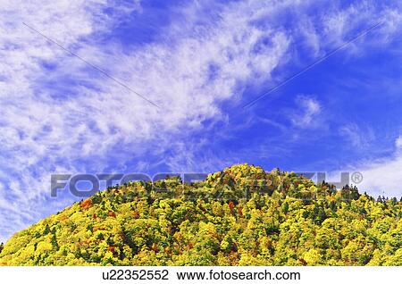 Stock Image - Blue Sky Over Mountain in Autumn. Fotosearch