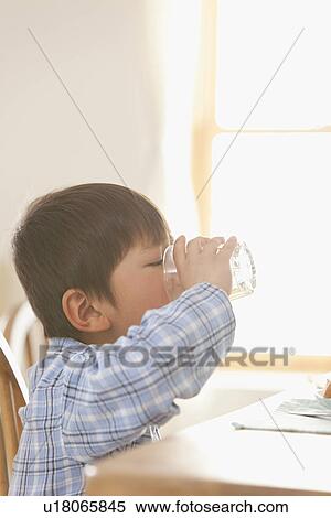 Boy Drinking at Breakfast Table View Large Photo Image Stock Photography - Boy Drinking at Breakfast Table. Fotosearch