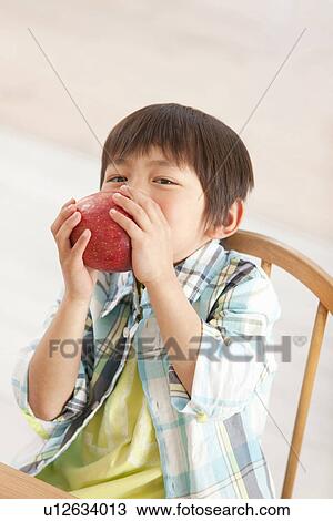 Stock Image - Boy Eating Apple. Fotosearch