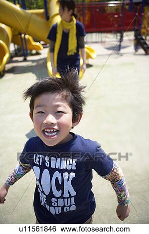 Stock Photograph - Boy Enjoying Himself in Playground. Fotosearch