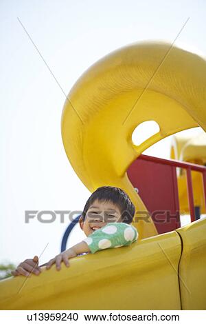 Stock Image - Boy on Slide. Fotosearch