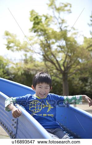 Boy on Slide View Large Photo Image Stock Photo - Boy on Slide. Fotosearch