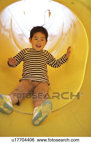 Stock Photograph - Boy on Slide. Fotosearch