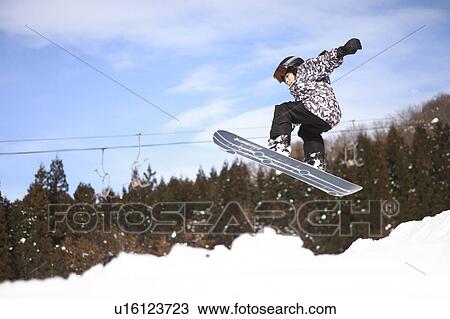 Stock Image - Boy snowboarding. Fotosearch