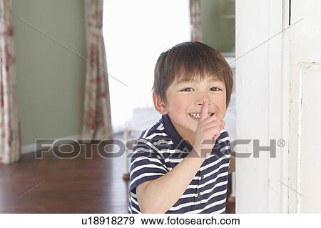 Stock Photo - Boy with Finger on Lips. Fotosearch