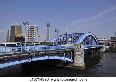 Stock Image - Bridge with Asahi Beer Hall and Tokyo Sky Tower. Fotosearch