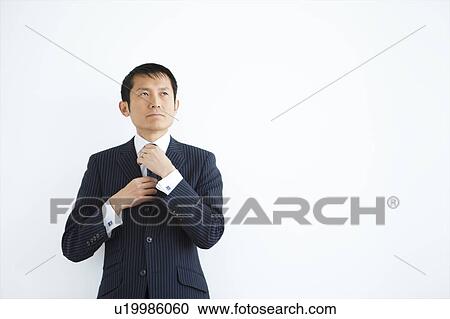 Businessman Adjusting Necktie View Large Photo Image Stock Image - Businessman Adjusting Necktie. Fotosearch