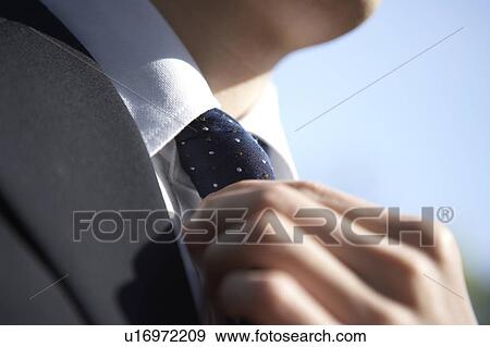 Businessman Adjusting Necktie View Large Photo Image Stock Photo - Businessman Adjusting Necktie. Fotosearch