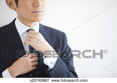 Businessman Adjusting Necktie View Large Photo Image Stock Photo - Businessman Adjusting Necktie. Fotosearch