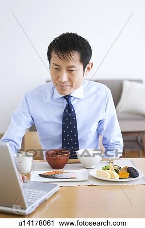 Businessman Reading Newspaper at Breakfast Table View Large Photo Image Stock Image - Businessman Reading Newspaper at Breakfast Table. Fotosearch