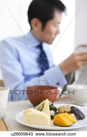 Businessman Reading Newspaper at Breakfast Table View Large Photo Image Stock Image - Businessman Reading Newspaper at Breakfast Table. Fotosearch