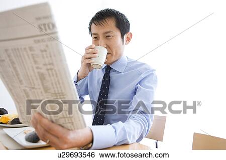 Businessman Reading Newspaper at Breakfast Table View Large Photo Image Stock Photograph - Businessman Reading Newspaper at Breakfast Table. Fotosearch