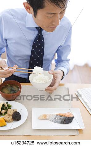 Businessman Reading Newspaper at Breakfast Table View Large Photo Image Stock Photography - Businessman Reading Newspaper at Breakfast Table. Fotosearch