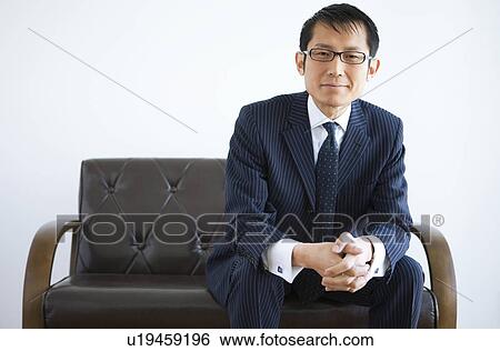 Businessman Sitting on Sofa View Large Photo Image Stock Photograph - Businessman Sitting on Sofa. Fotosearch