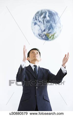Stock Photo - Businessman Throwing Globe. Fotosearch