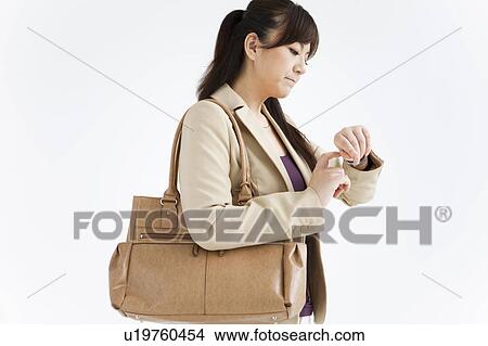 Picture - Businesswoman Checking Time. Fotosearch