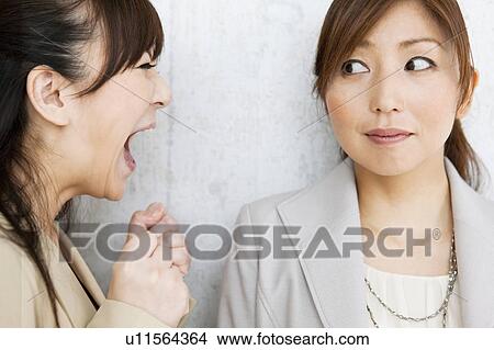Picture - Businesswoman Shouting at Colleague. Fotosearch