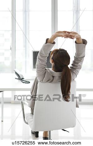Stock Photography - Businesswoman stretching. Fotosearch