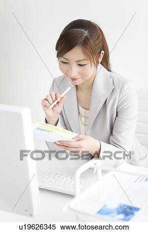 Stock Photography - Businesswoman Working at Desk. Fotosearch
