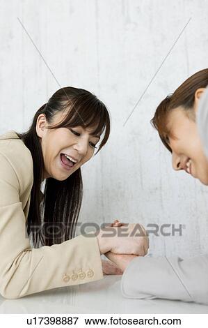Stock Photo - Businesswomen Arm Wrestling. Fotosearch