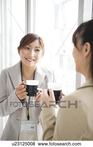 Stock Photo - Businesswomen Having Coffee Break. Fotosearch
