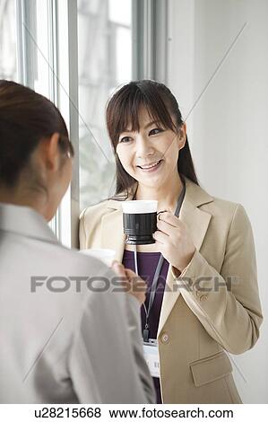 Stock Photo - Businesswomen Having Coffee Break. Fotosearch