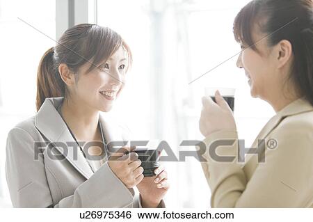 Stock Photograph - Businesswomen Having Coffee Break. Fotosearch
