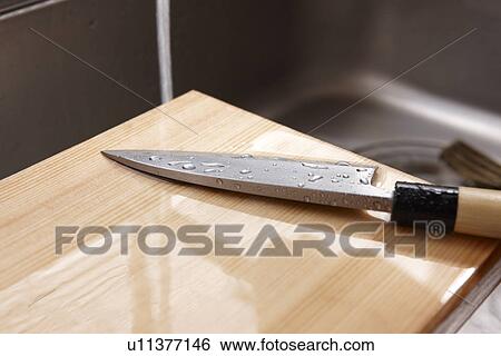 Stock Photograph - Clean Kitchen Knife and Cutting Board. Fotosearch