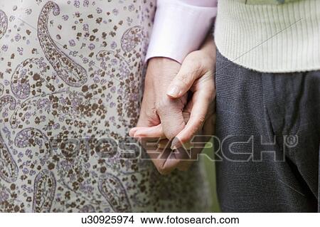 Picture - Close Up of Senior Couple Holding Hands. Fotosearch