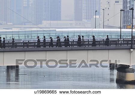 Stock Photography - Commuters Crossing Bridge. Fotosearch