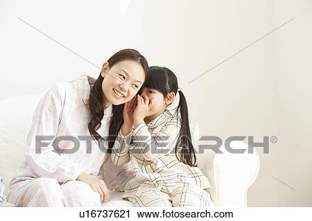 Daughter Whispering in Mother's Ear View Large Photo Image Stock Image - Daughter Whispering in Mother's Ear. Fotosearch