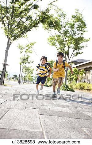 Stock Photo - Elementary school boys running, Japan. Fotosearch