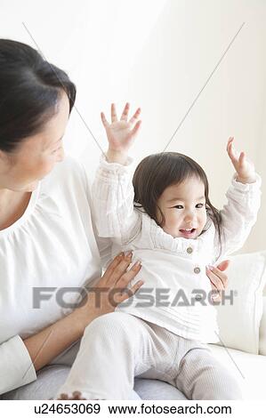 Excited Baby Girl on Mother's Lap View Large Photo Image Stock Photo - Excited Baby Girl on Mother's Lap. Fotosearch