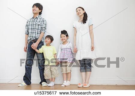 Stock Photo - Family of Four Looking up. Fotosearch