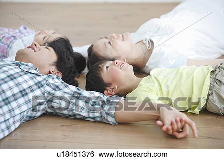 Family of Four Lying on Floor and Holding Hands View Large Photo Image Stock Photograph - Family of Four Lying on Floor and Holding Hands. Fotosearch