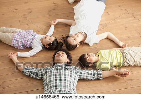 Family of Four Lying on Floor View Large Photo Image Stock Photograph - Family of Four Lying on Floor. Fotosearch