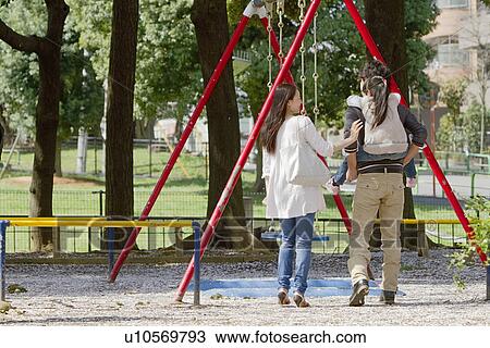 Stock Image - Family of Three at Playground. Fotosearch