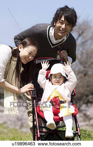 Stock Image - Family of Three in Park. Fotosearch