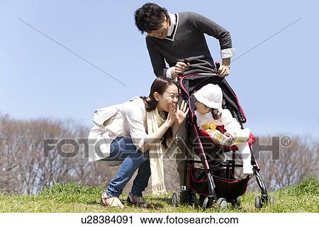 Stock Image - Family of Three in Park. Fotosearch