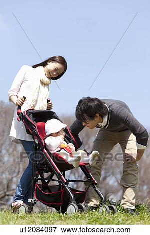 Stock Photo - Family of Three in Park. Fotosearch